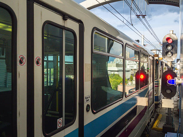 istock Modern Train at Station Platform with Signal Lights and Urban Skyline View 2236189929