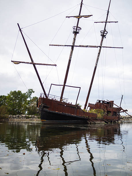 istock Abandoned Sailboat With Rusted Hull Reflecting on Calm Waters 2236189940