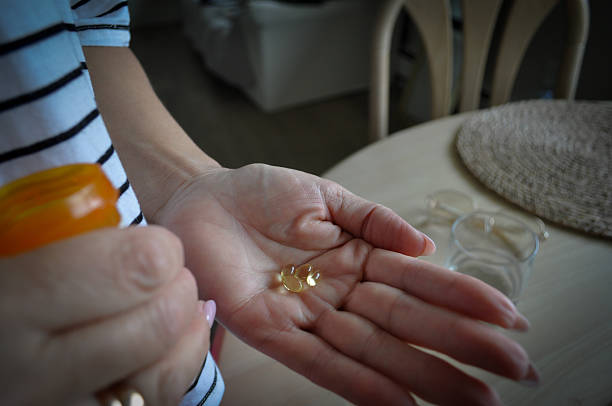 istock Woman holding supplements in hand for daily routine 2236190650