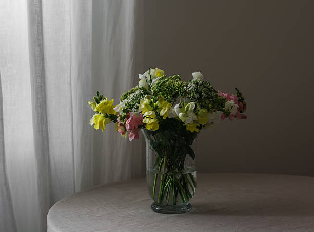 istock A bouquet of various garden flowers on a table with a gray tablecloth 2236192876
