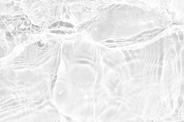 istock White water with ripples on the surface. Defocus blurred transparent white colored clear calm water surface texture with splashes and bubbles. Water waves with shining pattern texture background. 2236193095