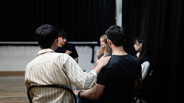 istock Closeup back view of unrecognizable sad man sharing life problem grief with multiracial people in modern mental health support group session in rehab center. Concept of mental health, psychotherapy. 2236194396