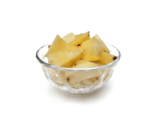 istock Fresh pineapple slices in bowl isolated on white background 2236194829