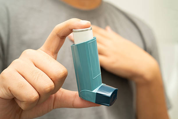 istock Asthma and chronic obstructive pulmonary disease COPD, Asian young man using metered dose inhaler MDI. 2236195333