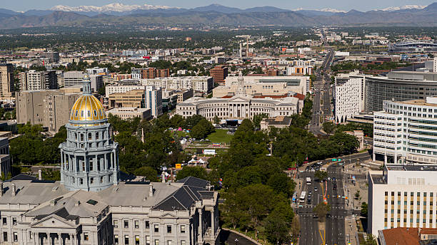 istock Mountain backdrop frames Civic Center district with City and County Building behind Colorado State Capitol. Aerial view of central Denver governmental hub with snow-capped Rockies in distance. 2236196671