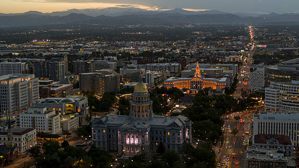 istock Rocky Mountain backdrop frames Capitol Hill district at dusk. City lights illuminate Denver, Colorado with Civic Center Park and government buildings. 2236196929