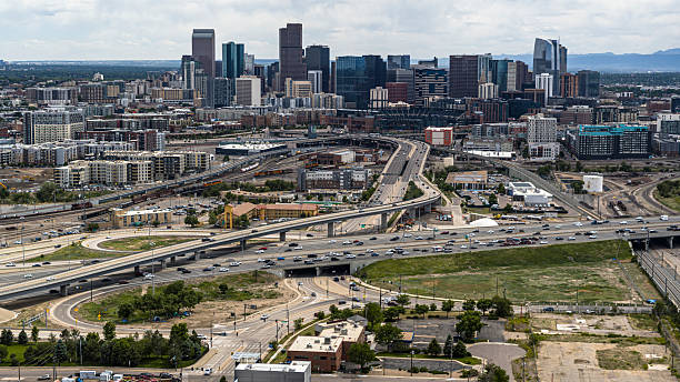 istock Skyline view from Five Points neighborhood showing highway interchange and rail yards. Business district of Denver, Colorado with Rocky Mountains in background. 2236197157