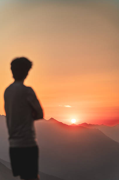 istock Person watching sunset over alpine mountains, Nockspitze, Austria 2236197523