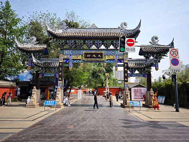 People walking at the gate of Wenshu Temple, or Wenshu Monastery, a Buddhist temple located in Chengdu, Sichuan, China.