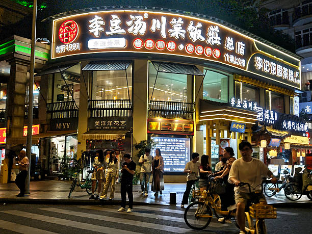 People walking on the busy Dongdajie street at night in Jinjiang central urban district, Chengdu, Sichuan, China.