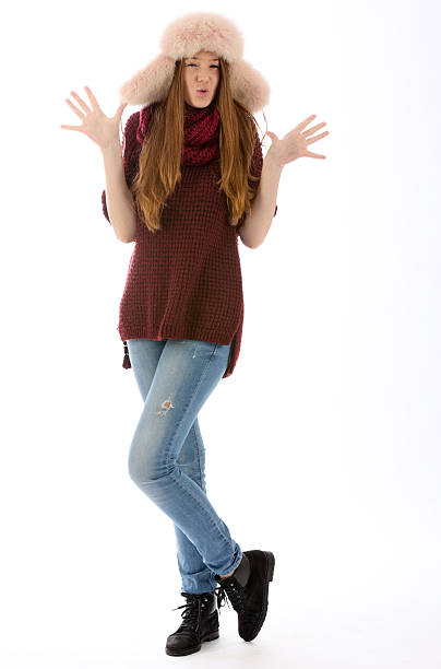 Funny young woman in fur hat says wow, shooting on white background