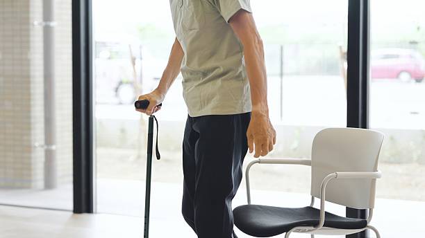 istock Elderly Asian man standing up with a cane 2236201580