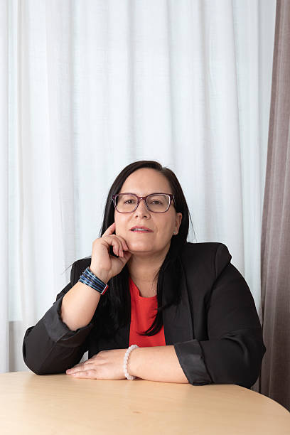 istock Mature executive in a reflective pose during an office conversation, attentive gaze with a calm expression. Concept of personal or business consulting 2236202647