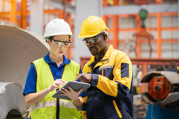 istock Two industrial workers reviewing digital data on a tablet in a factory environment. Modern technology, teamwork, and diversity in manufacturing industry.

Caption (TH): 2236203044