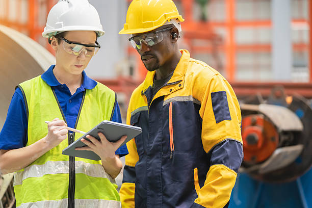 istock Two industrial workers reviewing digital data on a tablet in a factory environment. Modern technology, teamwork, and diversity in manufacturing industry.

Caption (TH): 2236203045