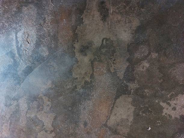 istock The concrete floor looks like it has a texture that shows various stains and black spots, with some areas appearing smooth and others rough, creating an abstract and rustic pattern 2236203253