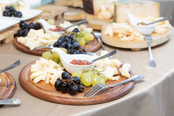 istock Catering cheese board displaying various cheeses, grapes, and jam 2236205663