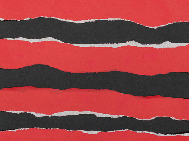 istock Strips of torn red paper on a black background. 2236209085
