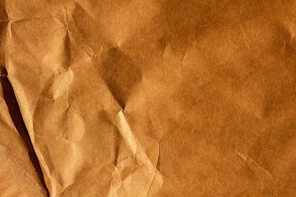 istock Brown crumpled creased paper background texture backdrop 2236209374