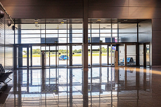 istock Large lobby with glass doors at the airport. Airport exit 2236209412