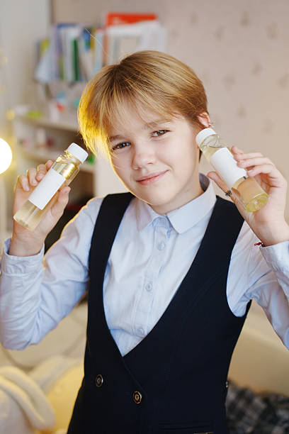 istock Boy holding diffuser liquids in a cozy room setting with playful smile 2236210347