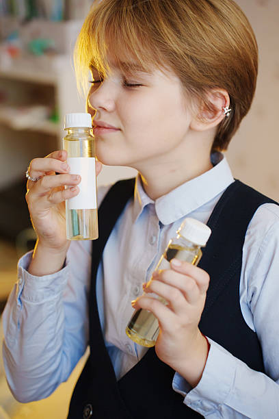 istock Young girl enjoys fragrant essential oils for aroma diffuser at home 2236210690