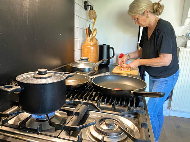 istock Senior Woman preparing Chicken in the Kitchen. 2236212599