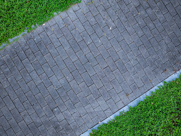istock Green lawn and stone paved walking path in the park 2236212899