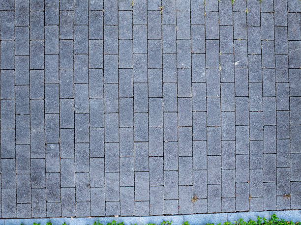 istock Green lawn and stone paved walking path in the park 2236212920