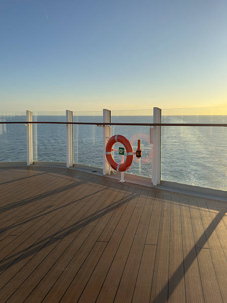 a red lifebuoy hangs on board a ferry cruise ship against the backdrop of a blue sea and a cloudless sky. High quality photo