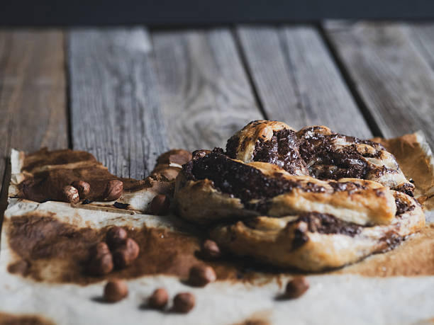 Homemade puff pastry with chocolate and hazelnuts on a rustic wooden table