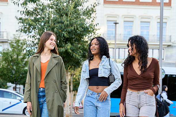 istock Three young women walking and talking in the city 2236216965