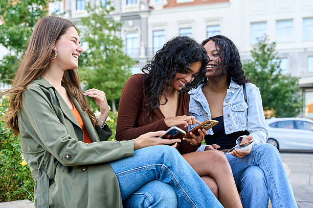 istock Three young women sharing funny content on smartphone in the city 2236217228