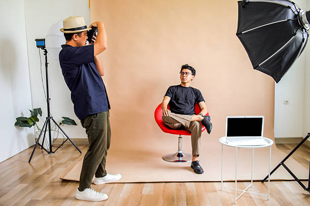 Photographer Captures Thoughtful And Confident Model Seated On Red Chair In Studio