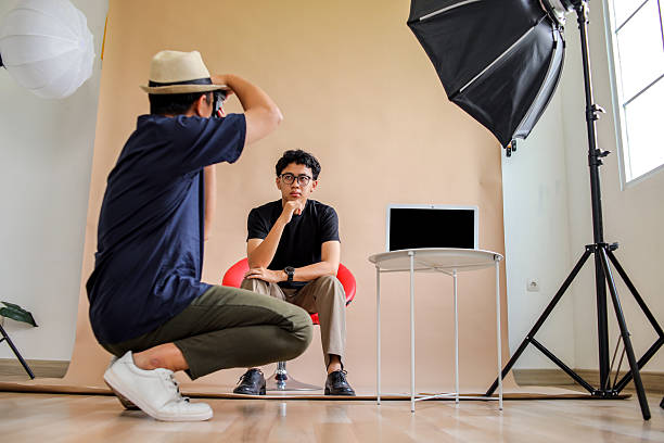 istock Photographer Captures Thoughtful And Confident Model Seated On Red Chair In Studio 2236217395