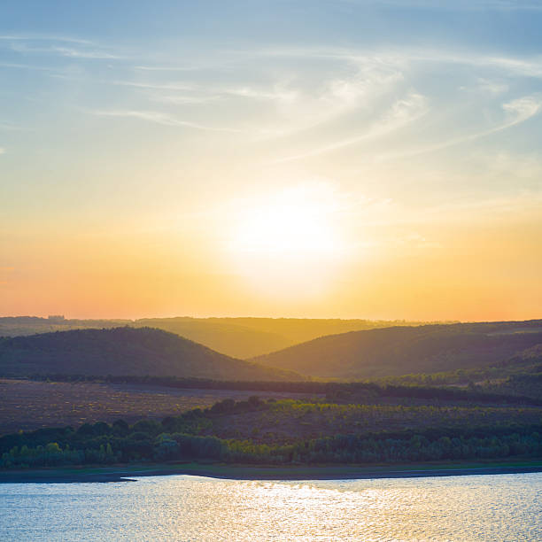 The light of the sunset hits the water surface.