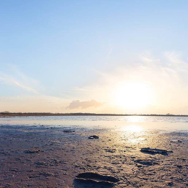 dry cracked saline land at the dramatic sunset