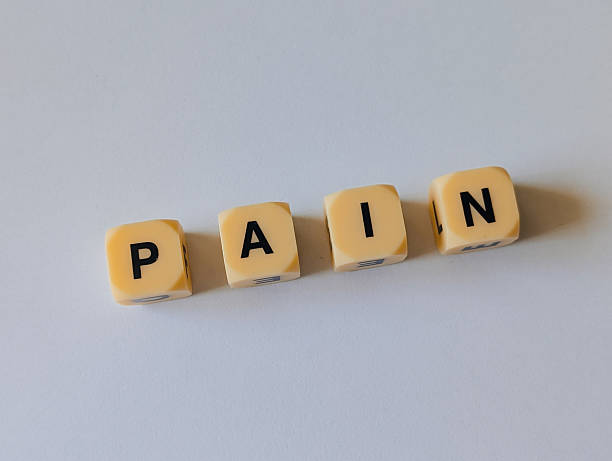 istock Yellow cubes with word PAIN on gray background 2236222303