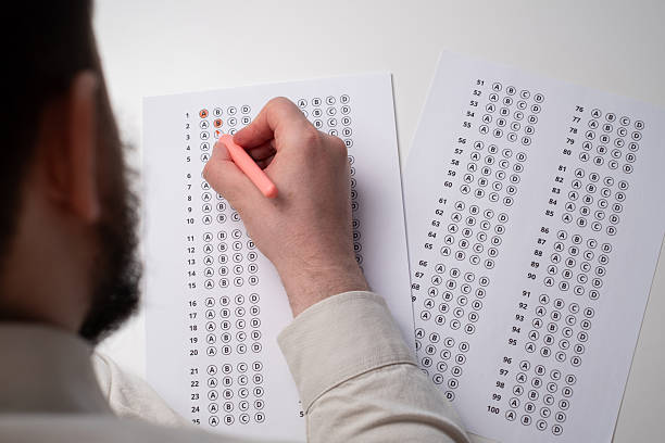 istock Admission test. Examination form. Choosing the correct answer. A sheet of paper with a test task. School exam. University quiz. Right or wrong option. Student to study. Elementary school question 2236222572