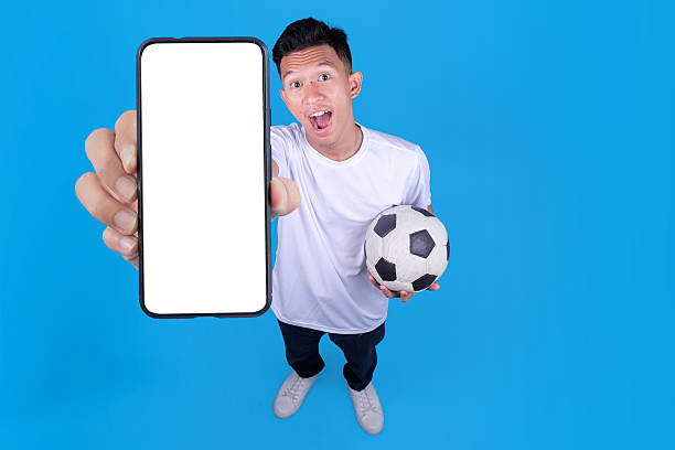 istock Soccer Fan Holding Blank Smartphone 2236223072