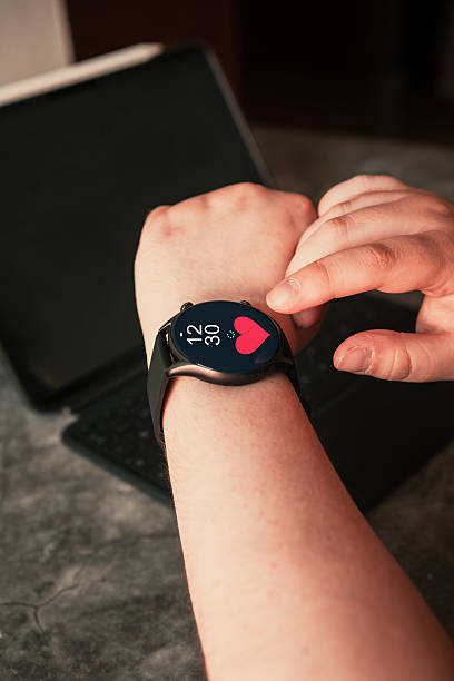 istock Woman checking her smartwatch with hologram screen interface of her daily activity. 2236223886