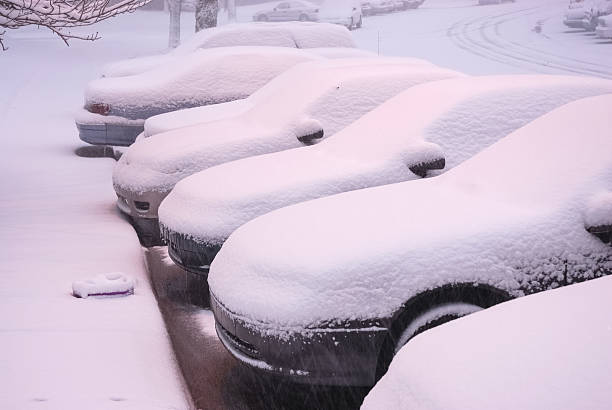 istock parking cars in a row under snow 2236223980