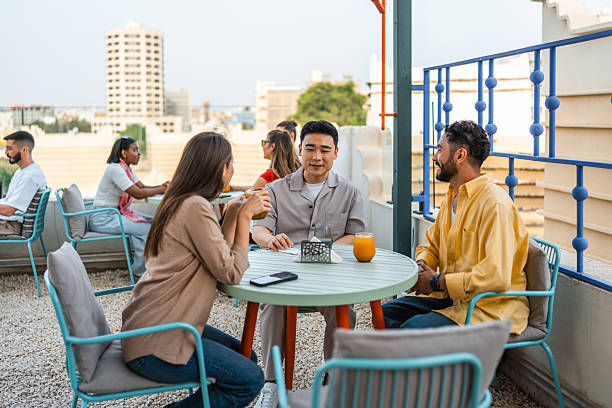 istock Diverse Young Adults Engaging at Rooftop Cafe 2236226698