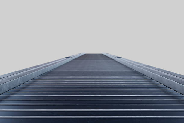 3D rendering of an empty conveyor belt in a warehouse or factory setting, symbolizing production flow, logistics readiness, or halted operations