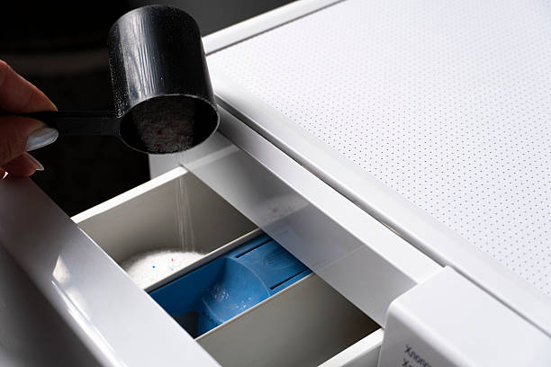 istock Pouring laundry detergent into washing machine drawer 2236231991
