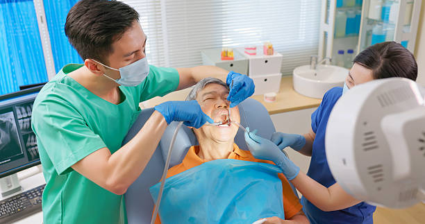 istock male dentist clean teeth of elderly patient 2236236519