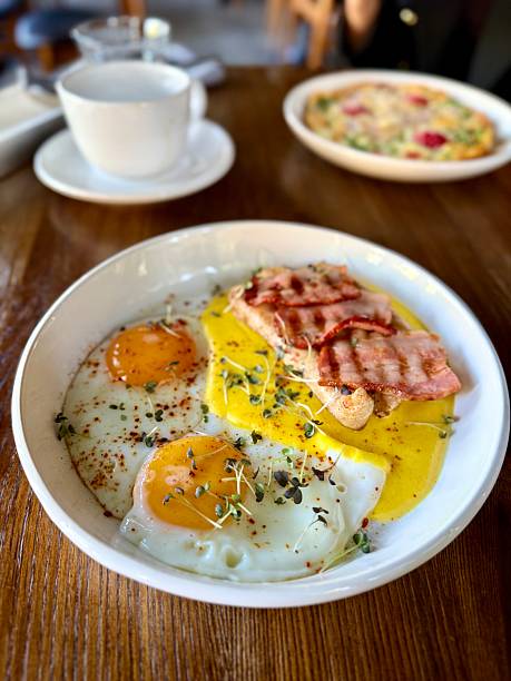 istock Fried eggs with toast and bacon served on plate 2236239805