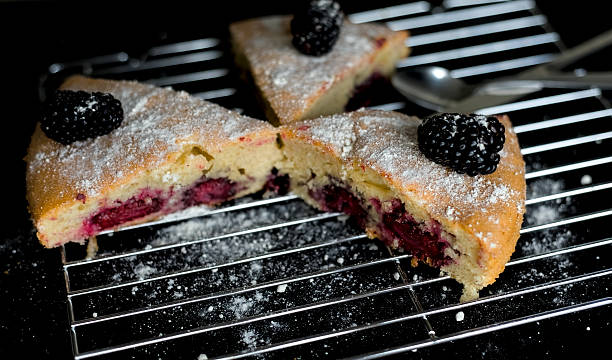 Fresh Blackberry Cake Slices on Baking Rack with Powder Sugar, Traditional British Summer Dessert