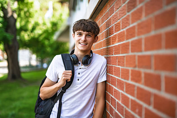 istock Portrait of smiling elementary school boy with his backpack 2236242405