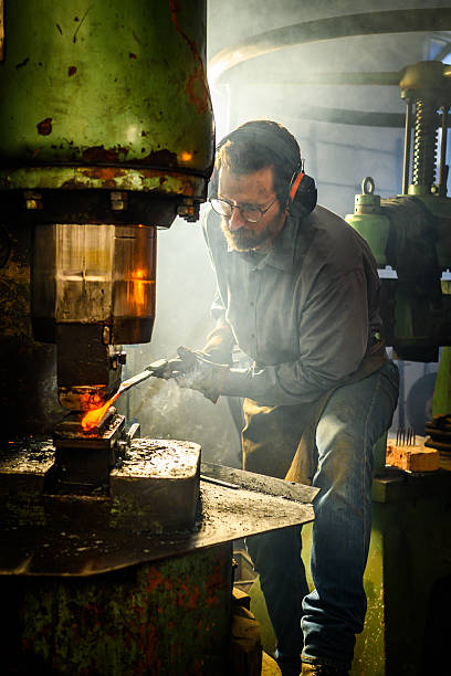 istock Mid Adult Caucasian Metalworker Operating Hydraulic Press 2236243657